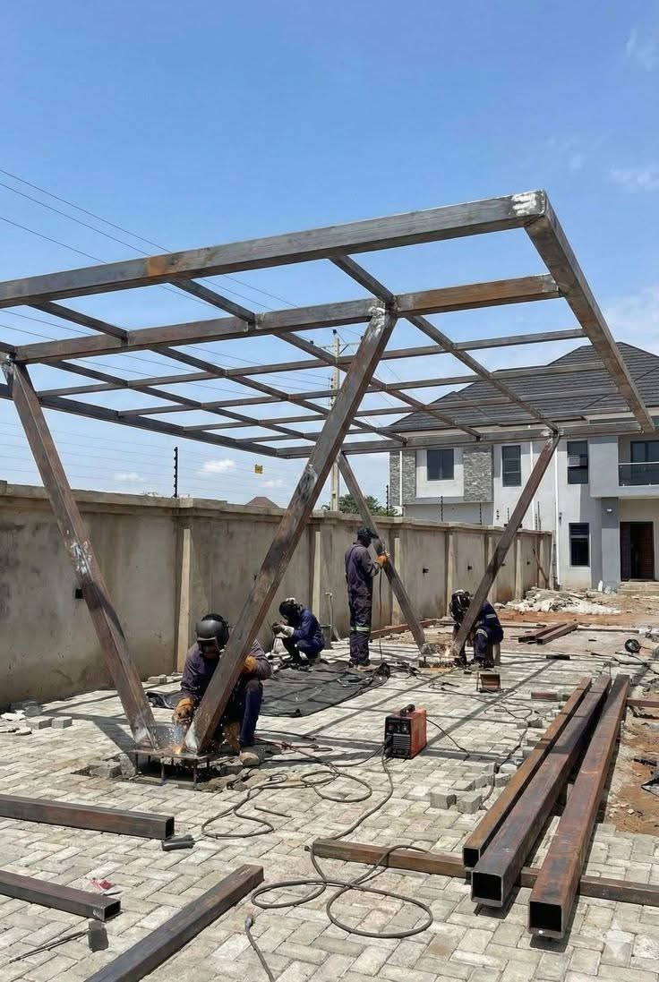 Steel canopy frame being erected on site over a driveway