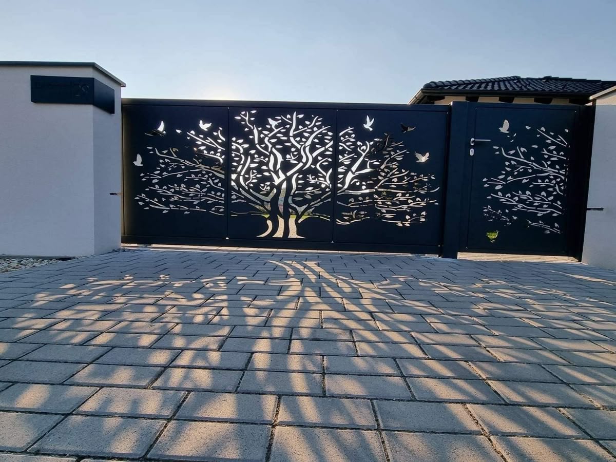 Navy driveway gate with laser-cut tree and butterfly motif panels